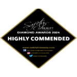 A black diamond-shaped badge with gold border reads “Safety in Beauty Diamond Awards 2024 Highly Commended.” Below are website and social media icons for Facebook, Instagram, and Twitter.